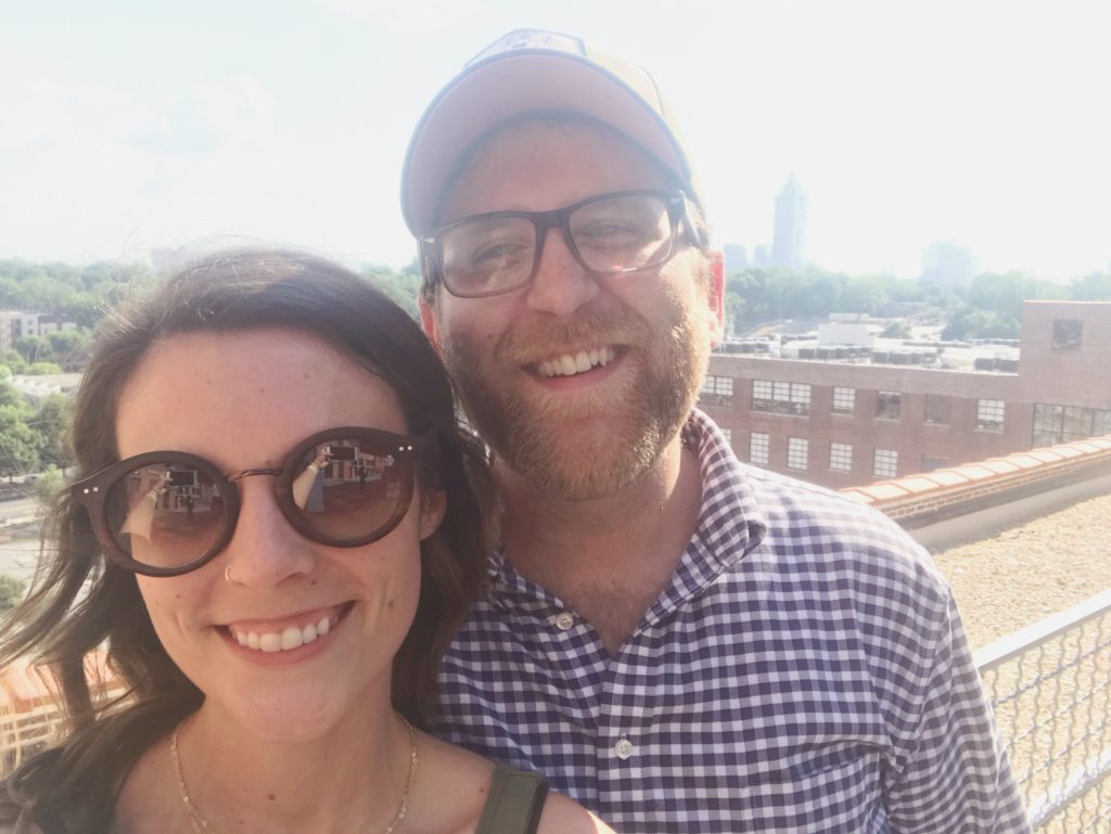 Jess and Eric selfie overlooking Atlanta skyline
