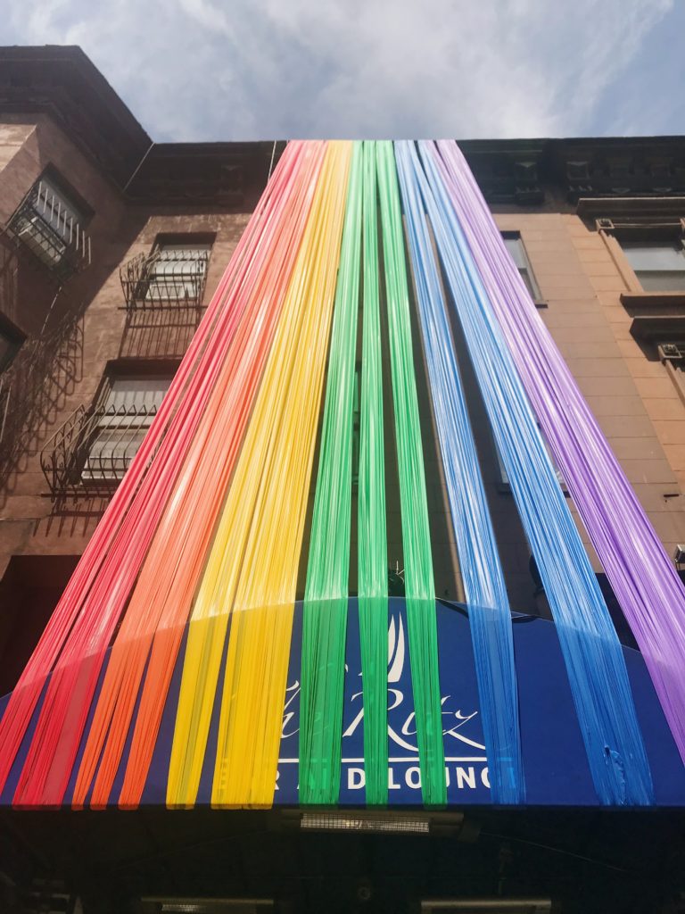 rainbow streamers hung on a new york building for pride month
