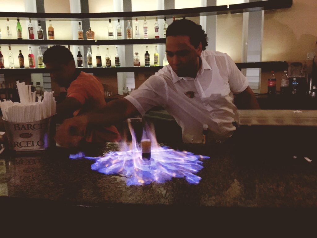 bartender makes flaming B-52 shots